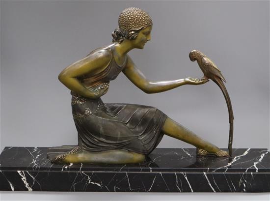 An Art Deco spelter figure of a girl with a bird, signed D.H. Chiparus base length 60cm